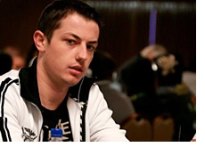 -- Tom Dwan at the table - playing with chips --