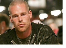 Patrik Antonius stares down at the cards on the table