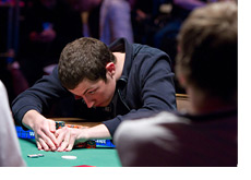 Tom Dwan taking a peek at the cards he was dealt