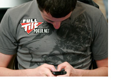 -- Tom Dwan playing on his mobile phone --